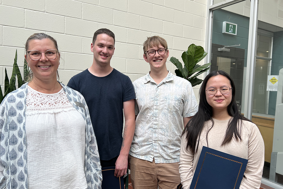 Poster day winners are congratulated by Dr. Lynn Weber, associate dean of research at the WCVM.
