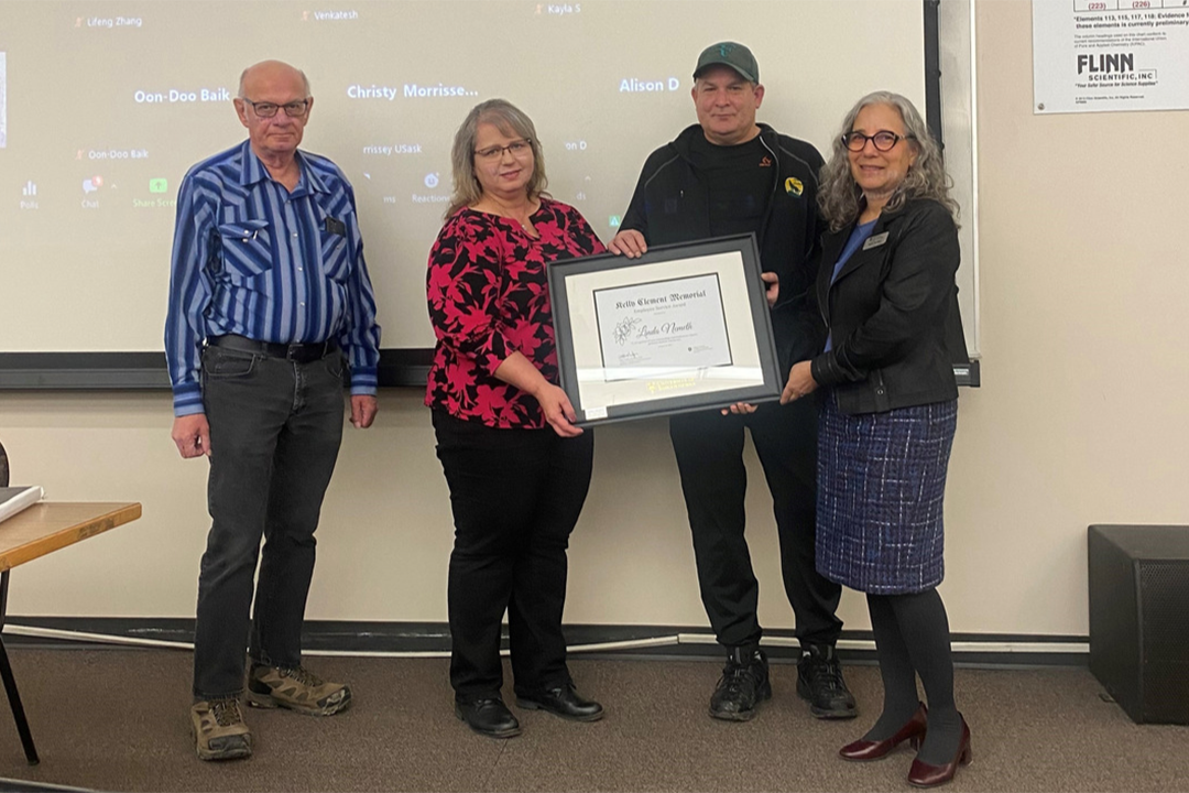 award recipient Linda Nemeth accepts award from Clement's family