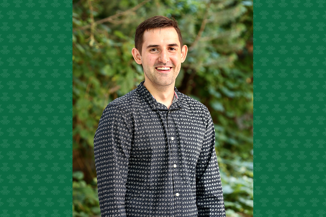 Cody Koloski (male) in front of trees.