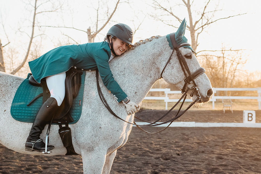 Laura Callaghan hugs her dressage horse, Llama.