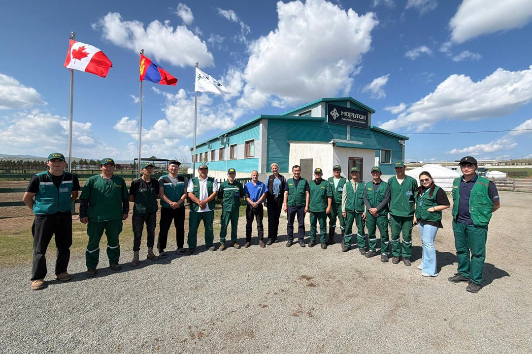 Group of people posing in front of an equine hospital